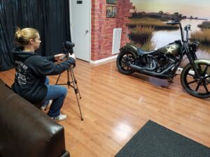 Photo of Carla photographing a motorcycle.